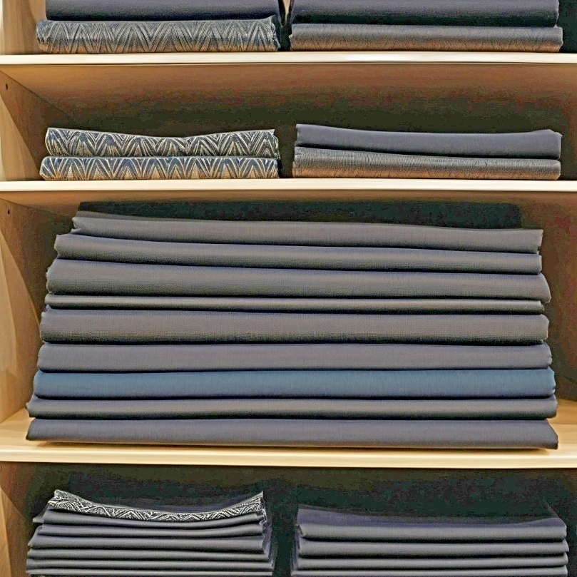 Image of dark fabrics on a shelf